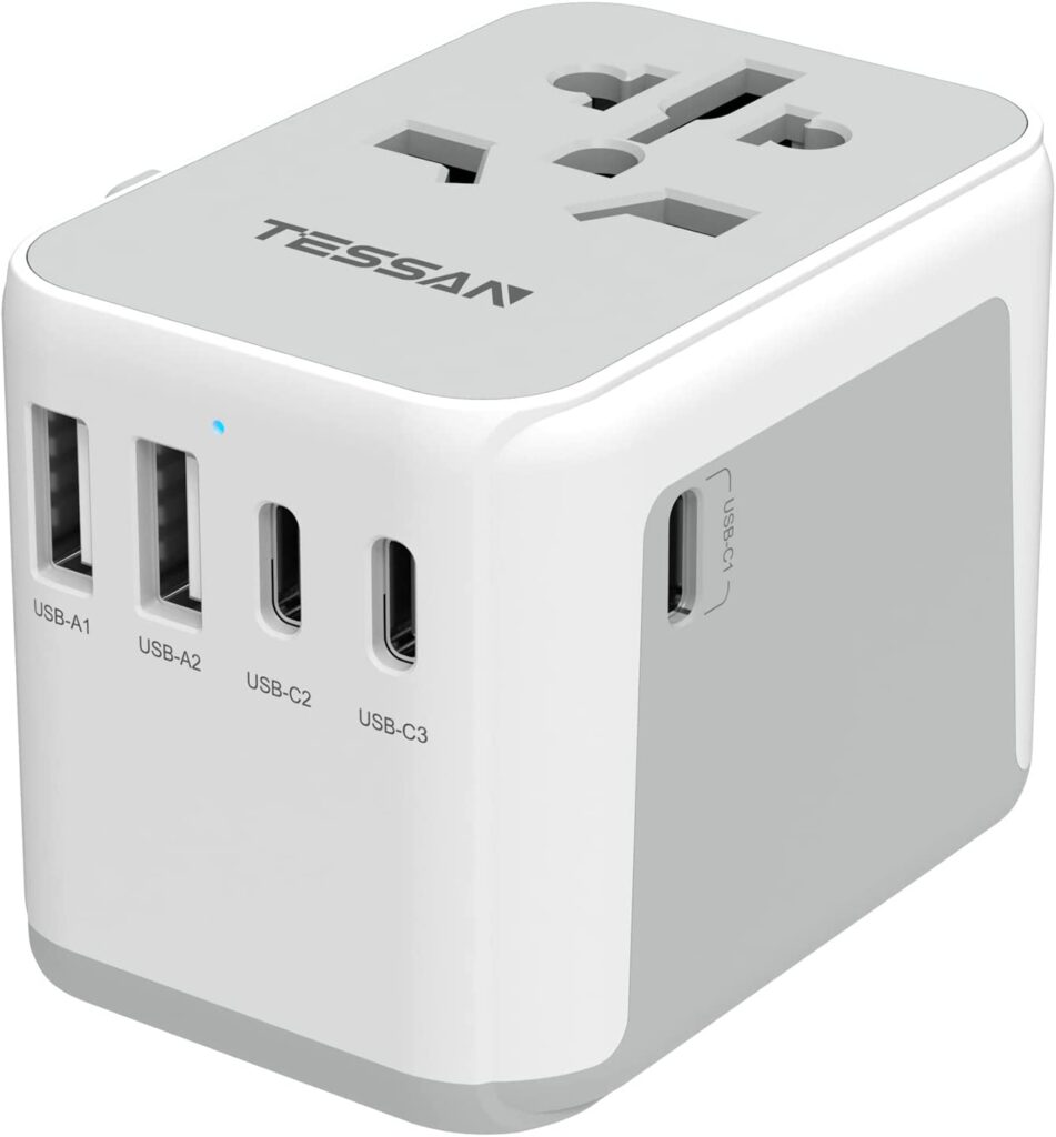 A white and grey cubed adaptor for when one travels internationally.