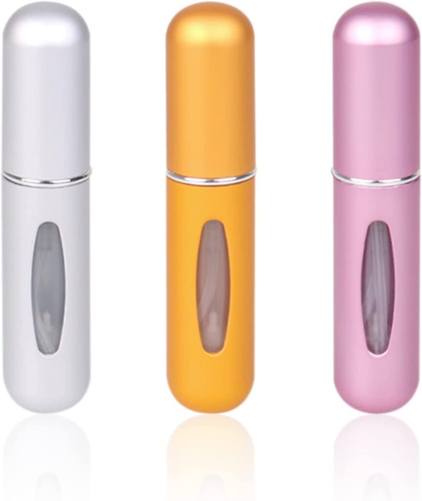 Three refillable perfume bottles in different colors.