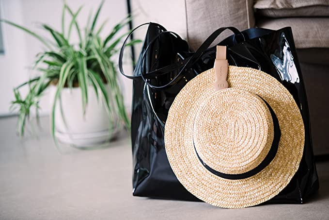 A magnetic hat clip holding a hat and bag together.