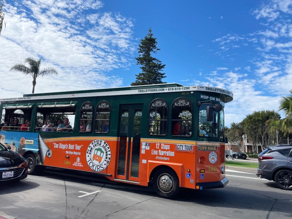 The Old Town Trolly in the streets of Coronado with passengers on board.