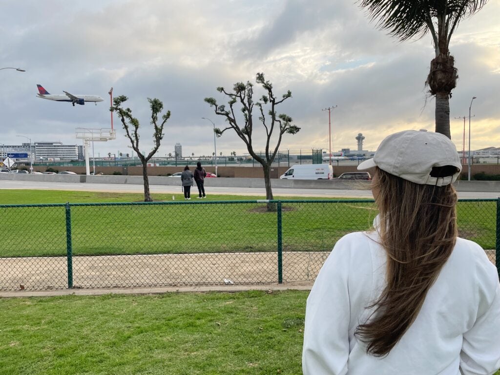 Jenn stands at the Airplane landing viewpoint to watch the planes fly into the runway.