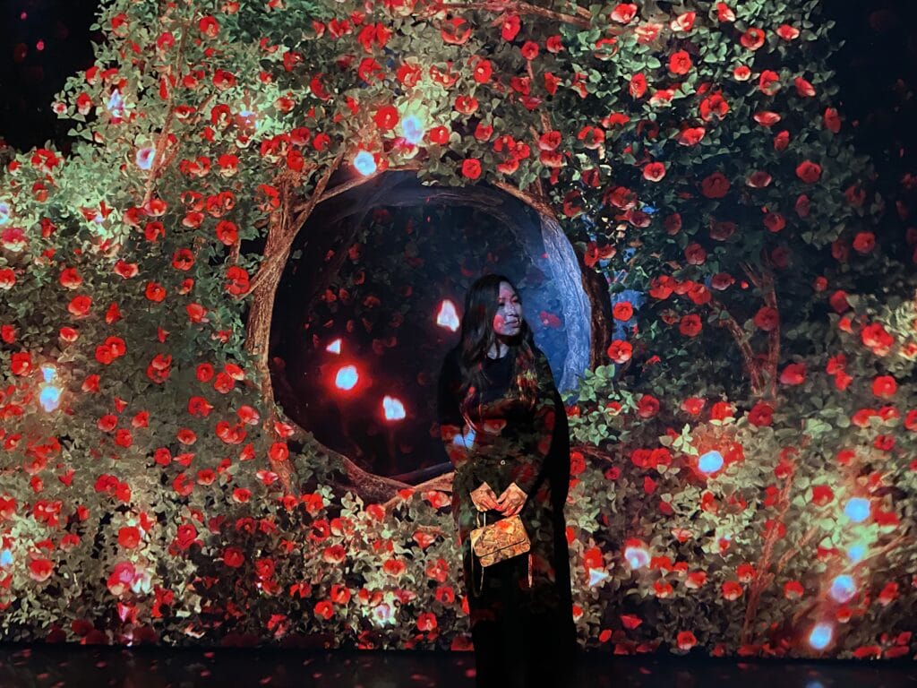 Jenn stands in front of the 'Flower Camellia' installation at the Arte Museum.