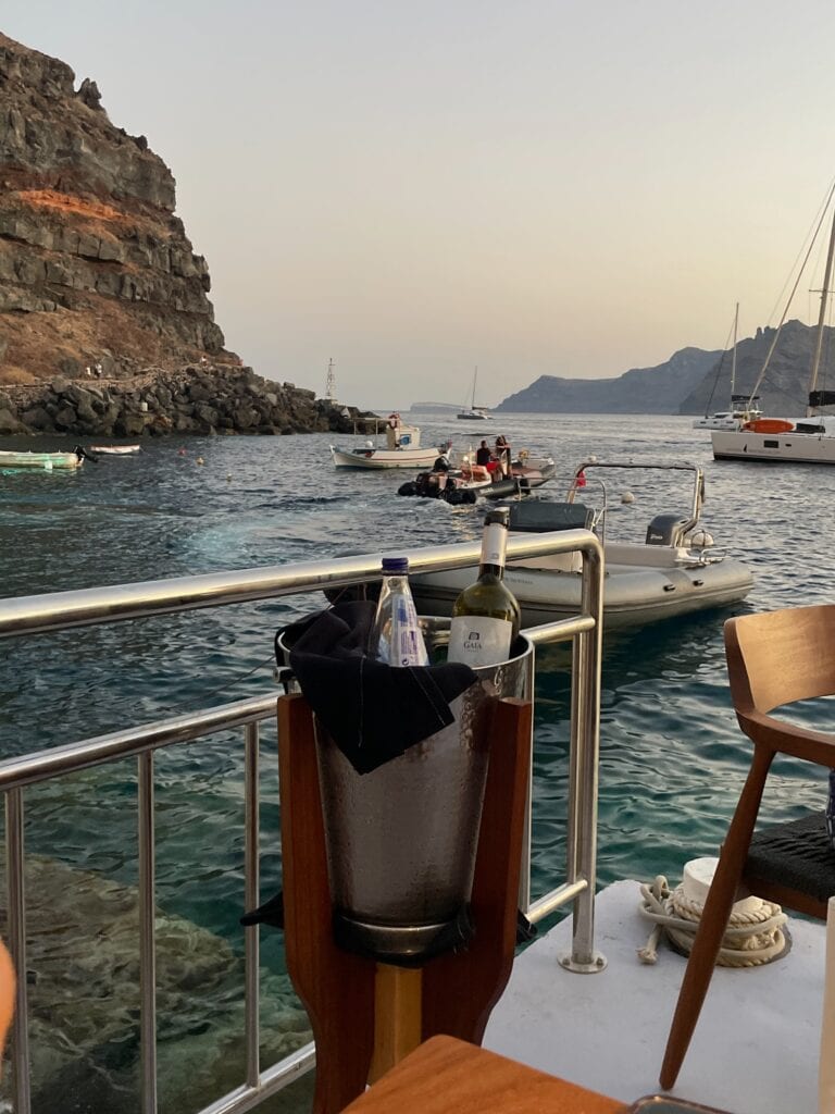 bucket with boats and the Amoudi Bay in the background.